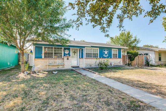 ranch-style home with stone siding, fence, and a front lawn