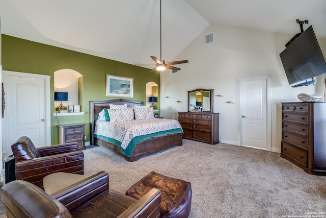 carpeted bedroom featuring baseboards, visible vents, arched walkways, ceiling fan, and high vaulted ceiling