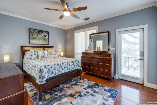 bedroom featuring wood finished floors, visible vents, baseboards, a ceiling fan, and ornamental molding