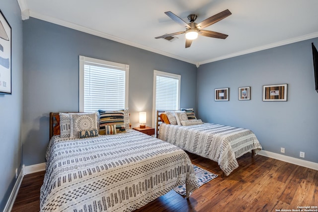 bedroom with crown molding, baseboards, and wood finished floors