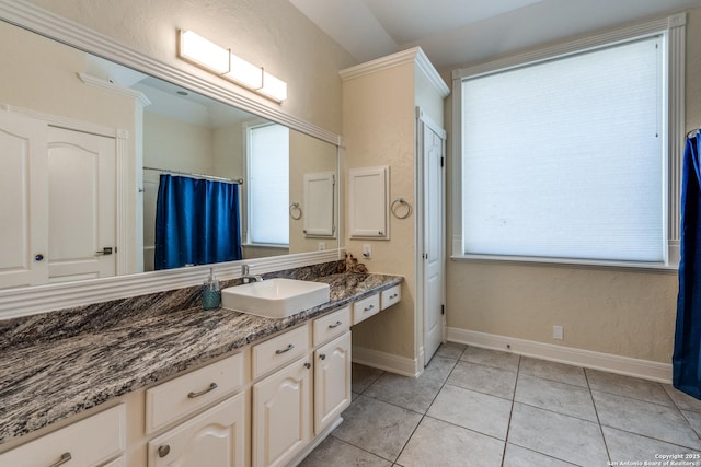 full bathroom with tile patterned flooring, vanity, and baseboards