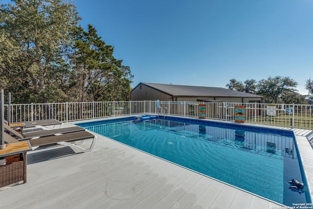 view of swimming pool with fence and a fenced in pool