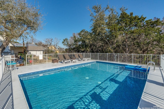 view of swimming pool featuring a fenced in pool