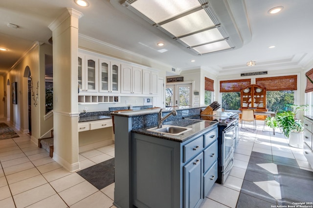 kitchen featuring electric stove, crown molding, white cabinets, and a sink
