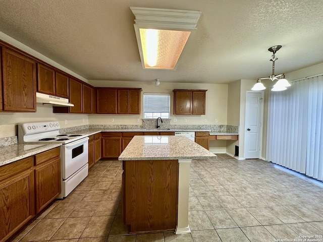 kitchen featuring a textured ceiling, under cabinet range hood, white appliances, a sink, and light stone countertops