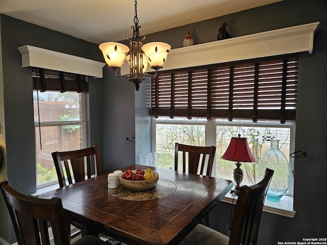 dining room featuring a wealth of natural light and a notable chandelier