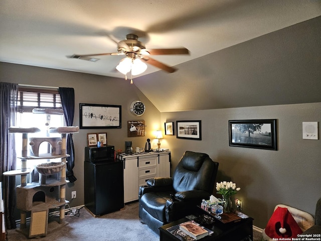 interior space with visible vents, a ceiling fan, vaulted ceiling, and carpet flooring