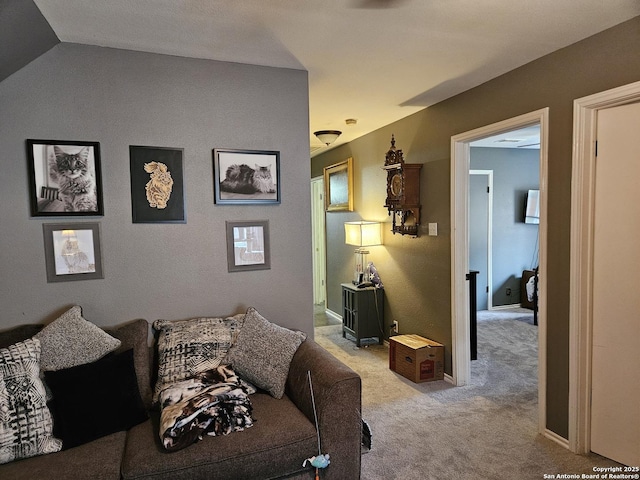 carpeted living room featuring vaulted ceiling and baseboards