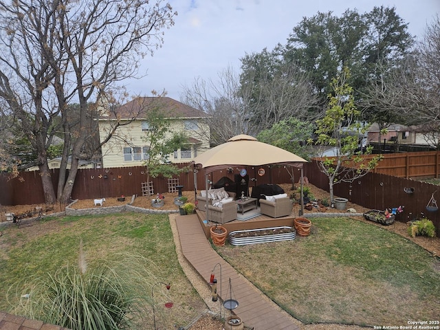 view of yard with outdoor lounge area, a fenced backyard, and a gazebo