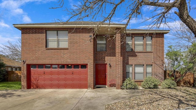 view of front facade with a garage, driveway, fence, and brick siding