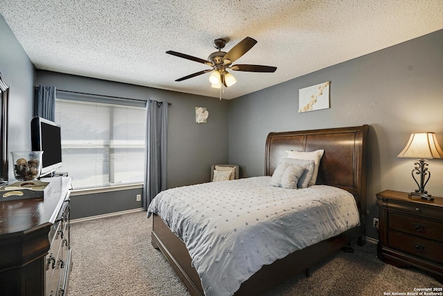 carpeted bedroom with ceiling fan, a textured ceiling, and baseboards