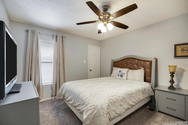 bedroom featuring a textured ceiling, carpet floors, and a ceiling fan