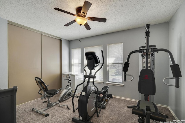 workout room featuring carpet floors, ceiling fan, baseboards, and a textured ceiling