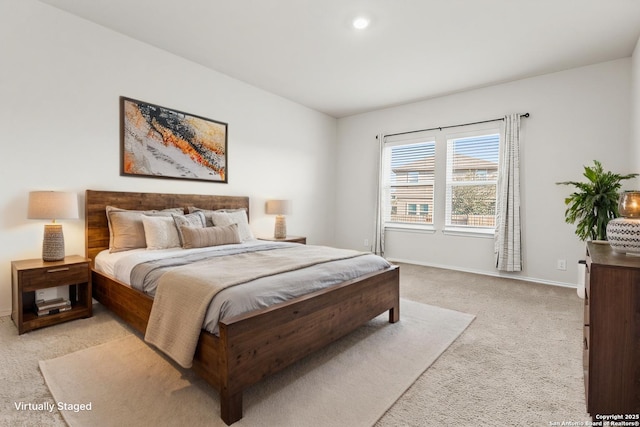 bedroom featuring baseboards and light colored carpet