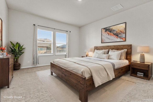 bedroom with baseboards, visible vents, and light colored carpet