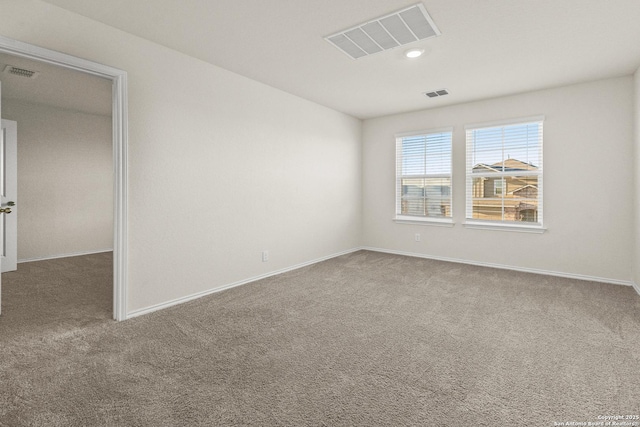 empty room with carpet and visible vents