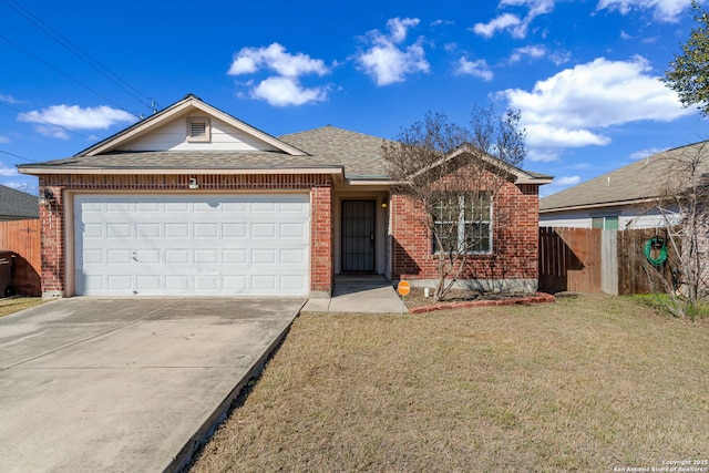 single story home with driveway, brick siding, an attached garage, fence, and a front yard