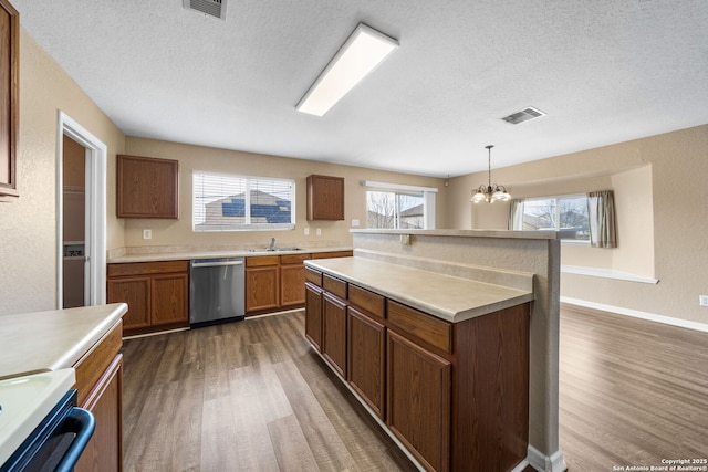 kitchen with dishwasher, stove, a sink, and dark wood finished floors