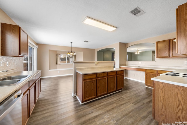 kitchen featuring brown cabinets, dark wood finished floors, visible vents, stainless steel dishwasher, and a sink