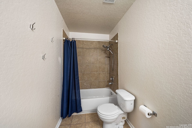 bathroom with tile patterned flooring, a textured wall, a textured ceiling, and toilet