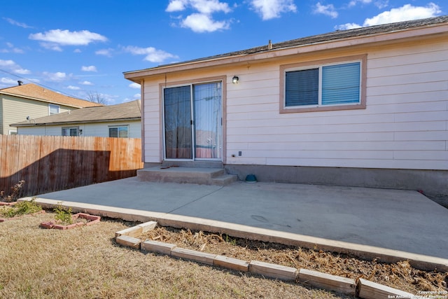 rear view of property with a patio and fence