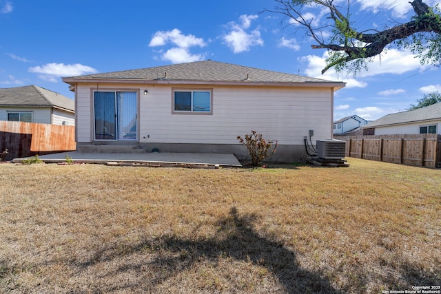 back of house featuring central AC, a yard, a patio area, and fence