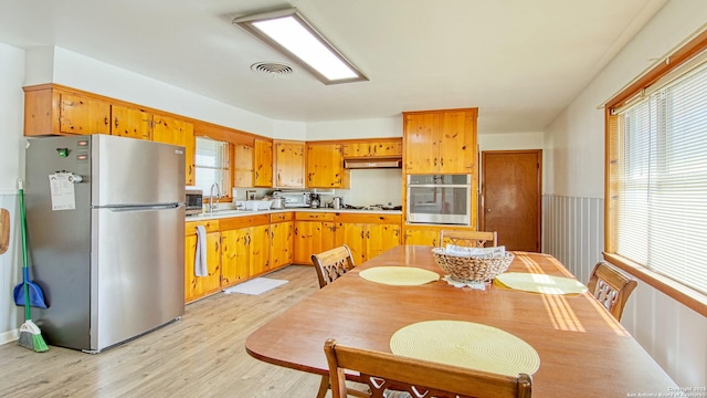 kitchen featuring stainless steel appliances, visible vents, and a healthy amount of sunlight