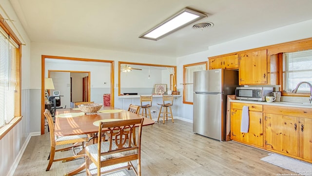 kitchen featuring light countertops, visible vents, light wood-style flooring, appliances with stainless steel finishes, and a sink