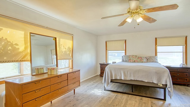 bedroom with baseboards and light wood-style floors