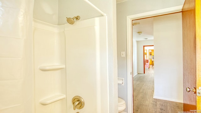 full bath featuring toilet, baseboards, and wood finished floors