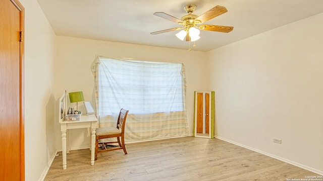 home office featuring ceiling fan, wood finished floors, and baseboards