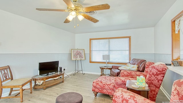 interior space with ceiling fan, wood finished floors, and baseboards