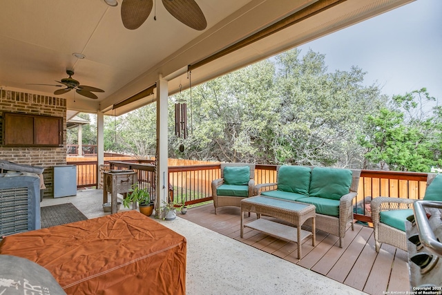 wooden deck with ceiling fan and outdoor lounge area