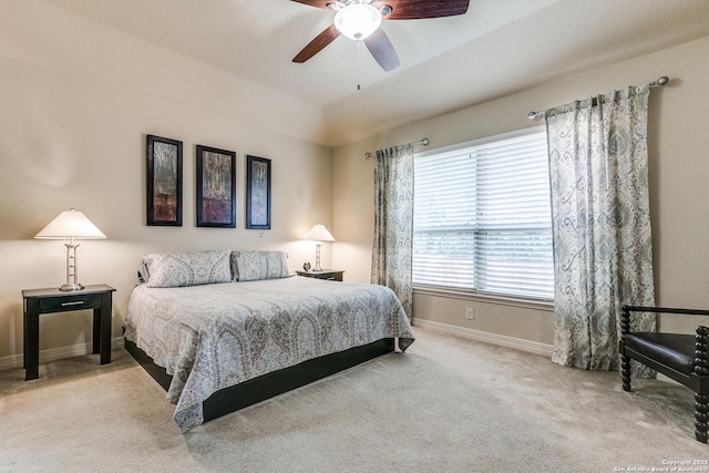 bedroom with carpet floors, vaulted ceiling, baseboards, and a ceiling fan