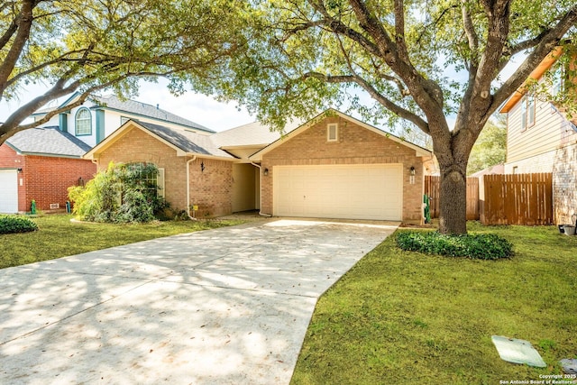 view of front of home featuring an attached garage, brick siding, fence, driveway, and a front lawn