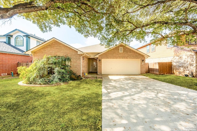 ranch-style home featuring an attached garage, brick siding, fence, driveway, and a front yard