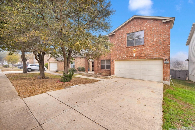 traditional home featuring brick siding, driveway, and an attached garage