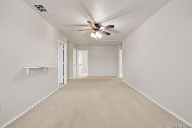 empty room featuring baseboards, light colored carpet, visible vents, and attic access