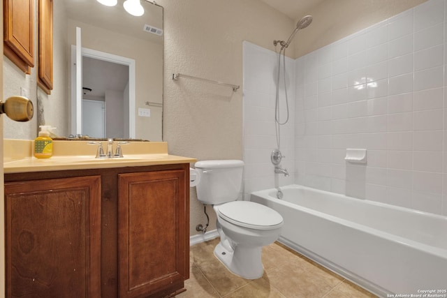 bathroom featuring a textured wall, toilet, vanity,  shower combination, and tile patterned floors