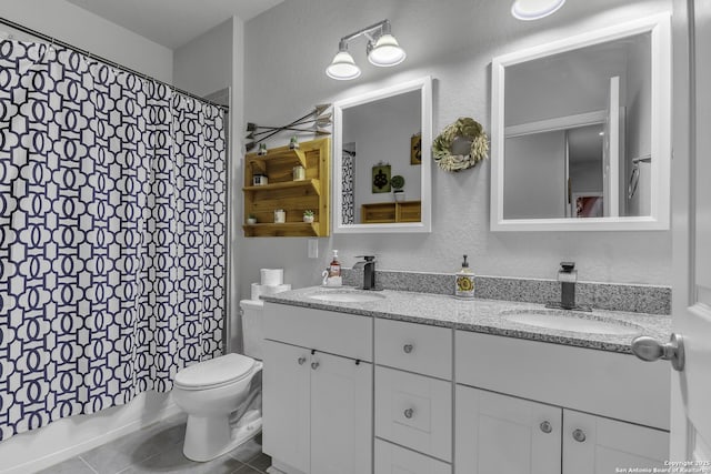 full bath featuring double vanity, a sink, toilet, and tile patterned floors