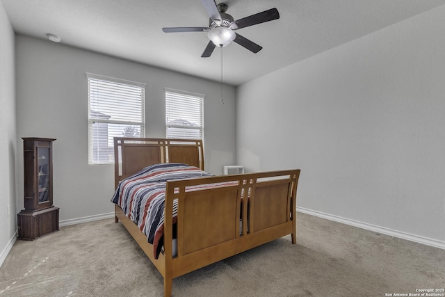 carpeted bedroom with a ceiling fan and baseboards