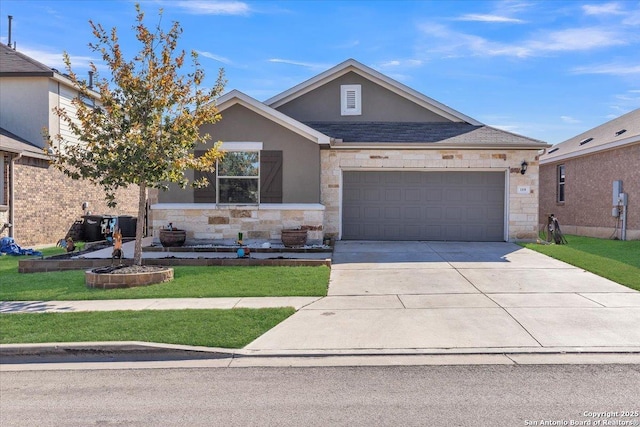 single story home featuring an attached garage, stone siding, concrete driveway, stucco siding, and a front yard