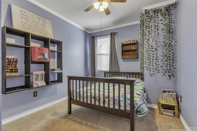 carpeted bedroom featuring ornamental molding, baseboards, and a ceiling fan