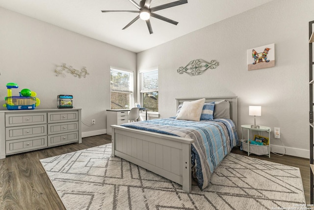 bedroom featuring a ceiling fan, baseboards, and wood finished floors