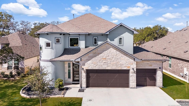 french provincial home with a garage, driveway, a shingled roof, and a front lawn