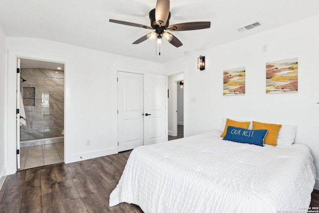 bedroom with ensuite bathroom, wood finished floors, a ceiling fan, visible vents, and baseboards