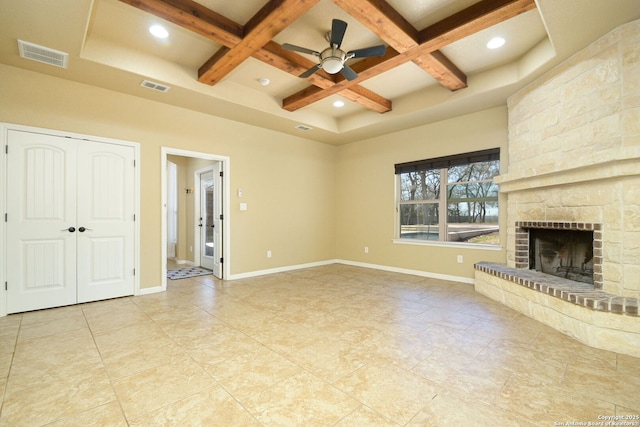 unfurnished living room with visible vents, baseboards, coffered ceiling, and a fireplace