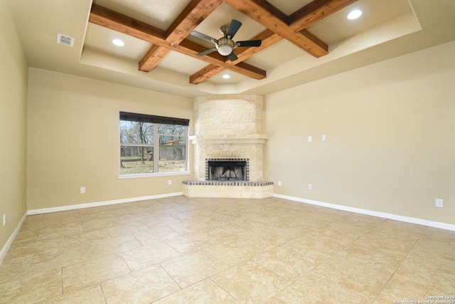 unfurnished living room featuring visible vents, baseboards, beam ceiling, a fireplace, and coffered ceiling