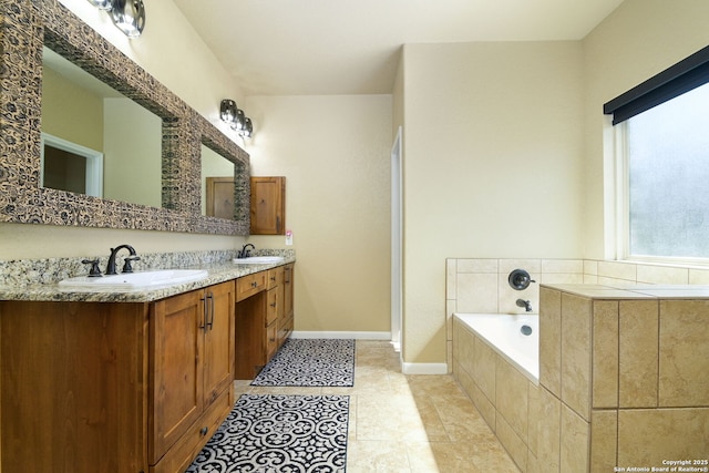 bathroom featuring double vanity, baseboards, a garden tub, and a sink