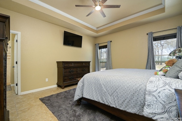 bedroom featuring a raised ceiling, light tile patterned floors, crown molding, and baseboards